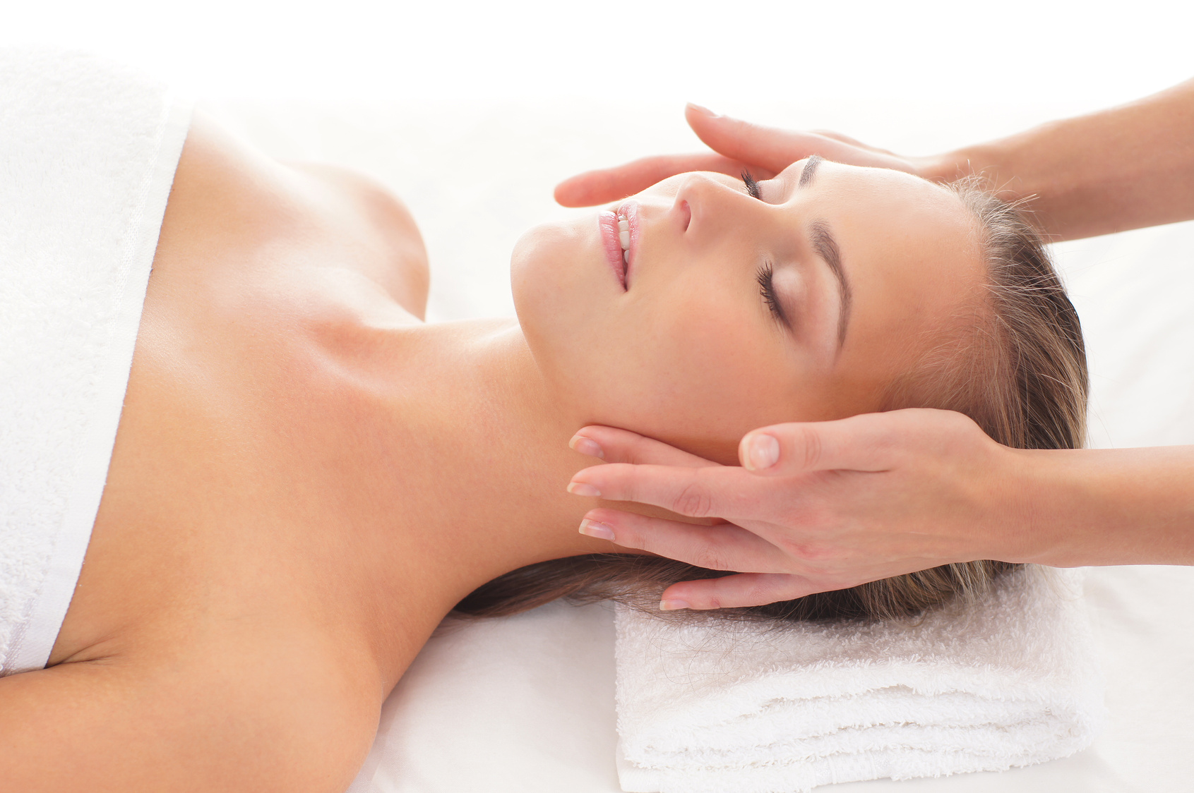 Young attractive woman getting spa treatment over white background